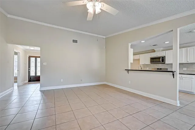 a view of a kitchen with a sink and dishwasher a refrigerator with white cabinets
