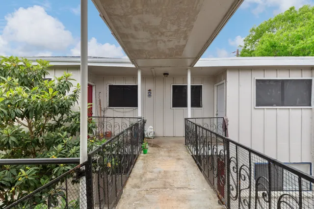 a view of a house with wooden fence