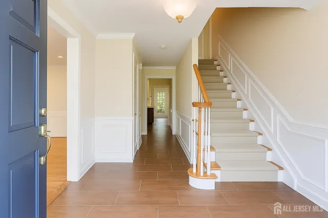 a view of entryway and hall with wooden floor
