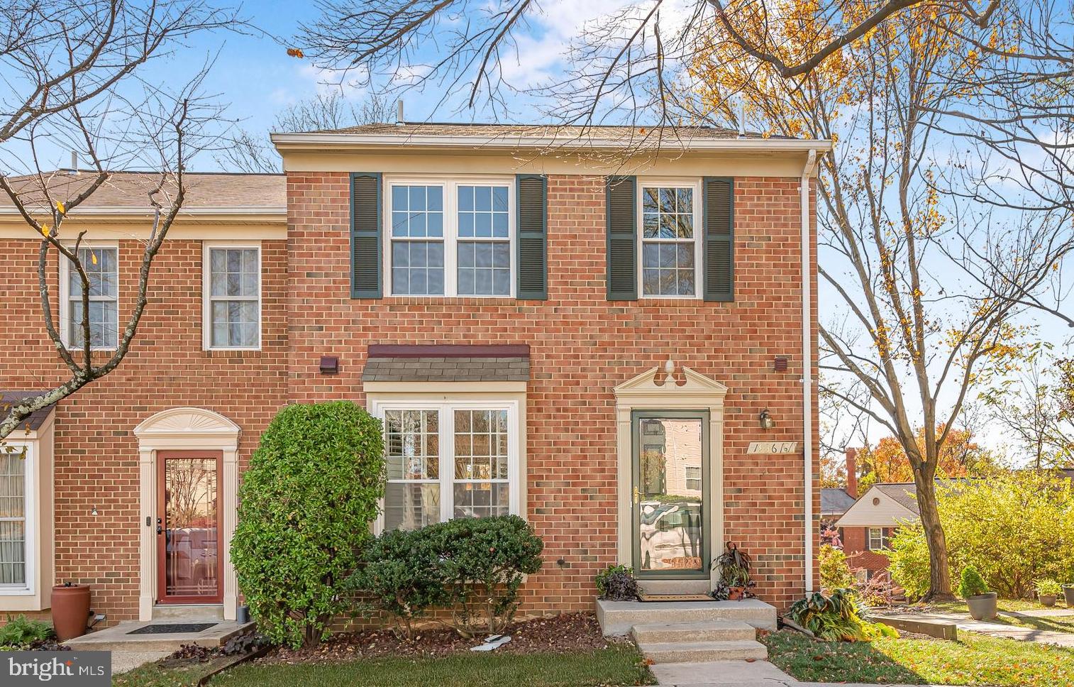1936 Flowering Tree Terrace Silver Spring, MD 20902 - Photo 1 of 26 front view of a brick house with a large windows