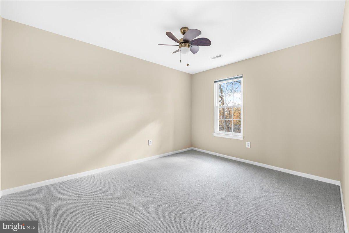 1936 Flowering Tree Terrace Silver Spring, MD 20902 - Photo 12 of 26 wooden floor in an empty room with a window
