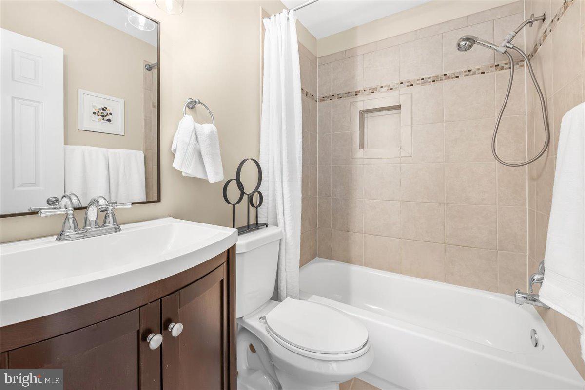 1936 Flowering Tree Terrace Silver Spring, MD 20902 - Photo 14 of 26 a bathroom with a sink a toilet and shower