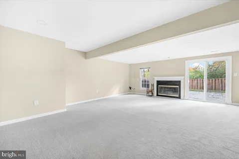 a view of empty room with a fireplace