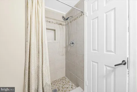 a bathroom with a glass shower door
