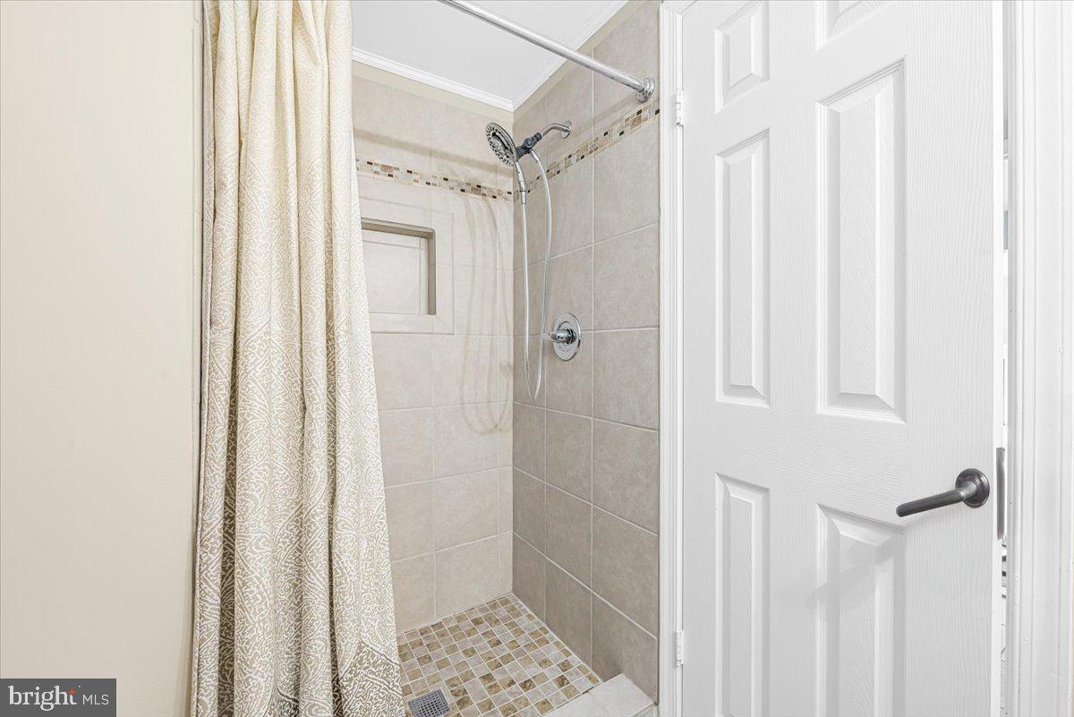 1936 Flowering Tree Terrace Silver Spring, MD 20902 - Photo 19 of 26 a bathroom with a glass shower door