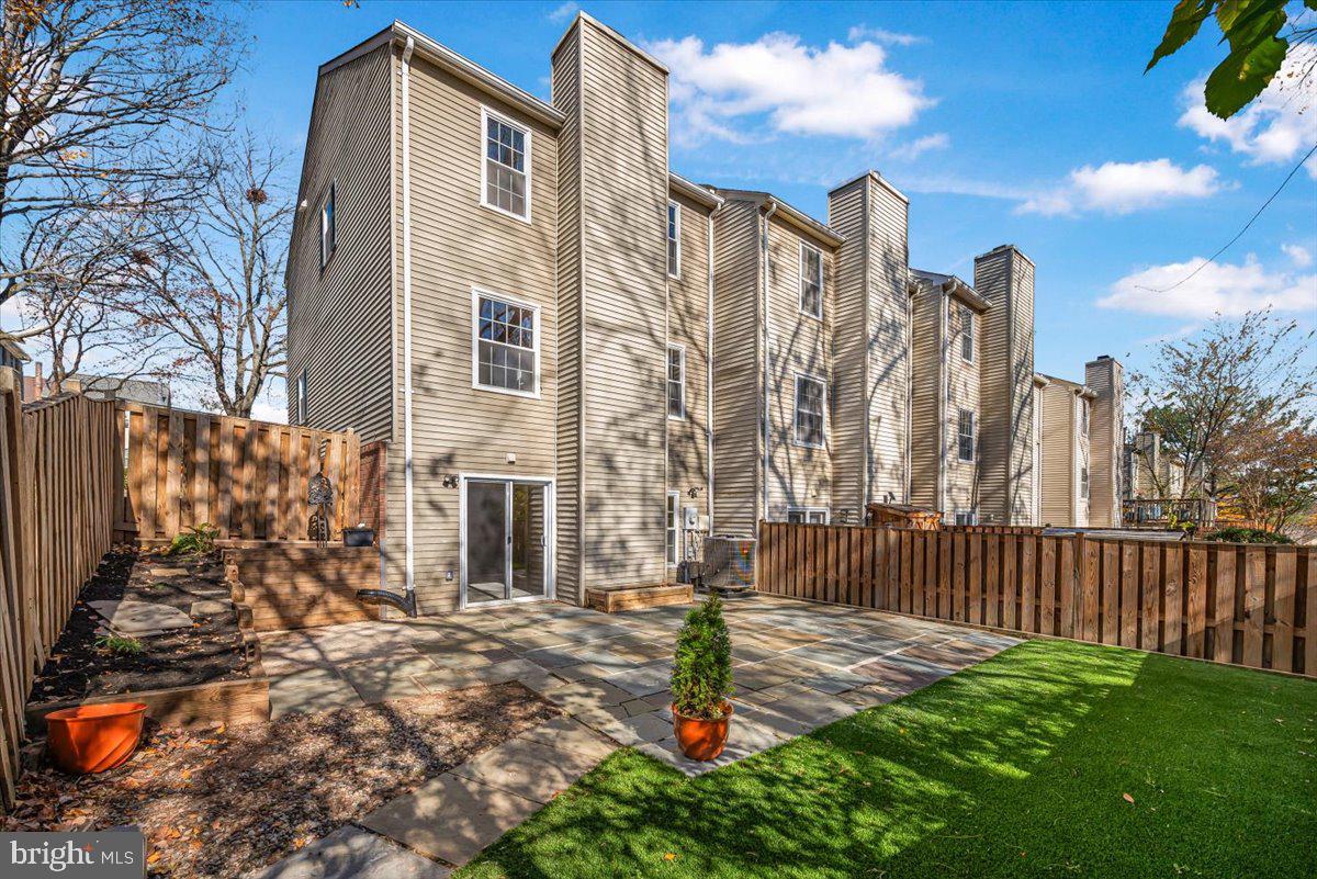 1936 Flowering Tree Terrace Silver Spring, MD 20902 - Photo 20 of 26 a front view of a house with garden