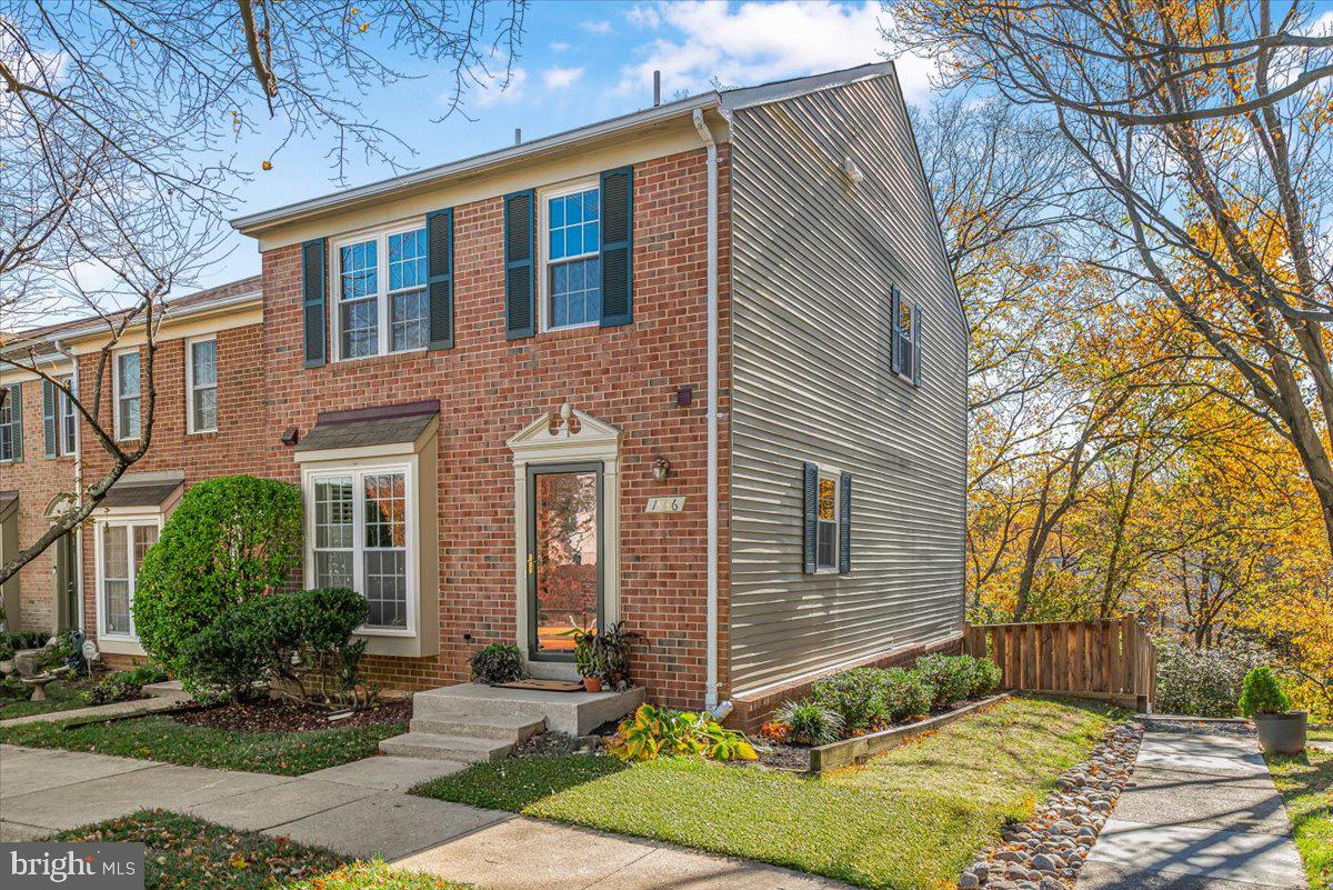 1936 Flowering Tree Terrace Silver Spring, MD 20902 - Photo 2 of 26 a front view of a house with a yard