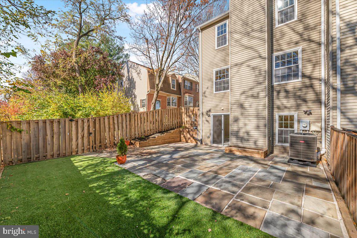 1936 Flowering Tree Terrace Silver Spring, MD 20902 - Photo 21 of 26 a view of a backyard with a wooden fence