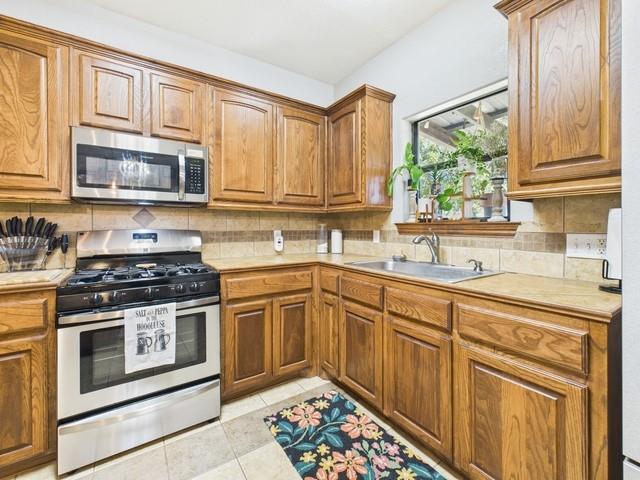 1675 Meadowview Street Athens, TX 75752 - Photo 12 of 40 a kitchen with stainless steel appliances granite countertop a stove sink and cabinets