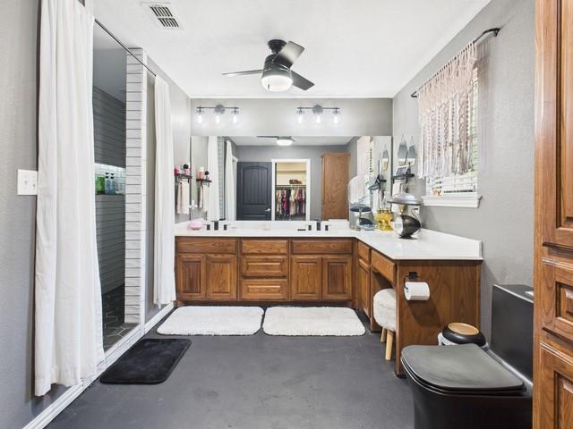 1675 Meadowview Street Athens, TX 75752 - Photo 17 of 40 a spacious bathroom with a double vanity sink and a mirror