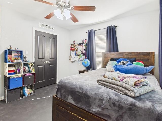 1675 Meadowview Street Athens, TX 75752 - Photo 27 of 40 a bedroom with a bed and a chandelier