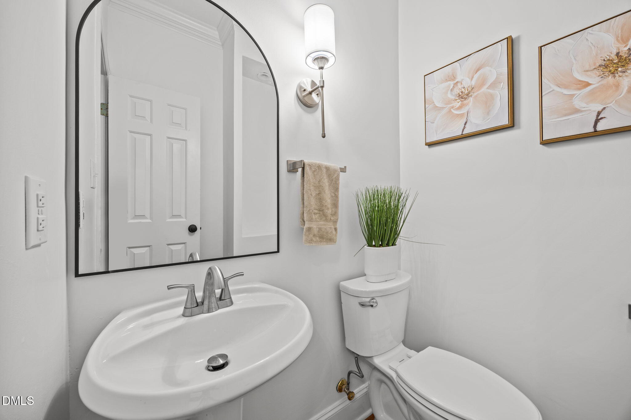3409 Sir Colleton Court Raleigh, NC 27612 - Photo 12 of 25 a bathroom with a toilet sink and mirror
