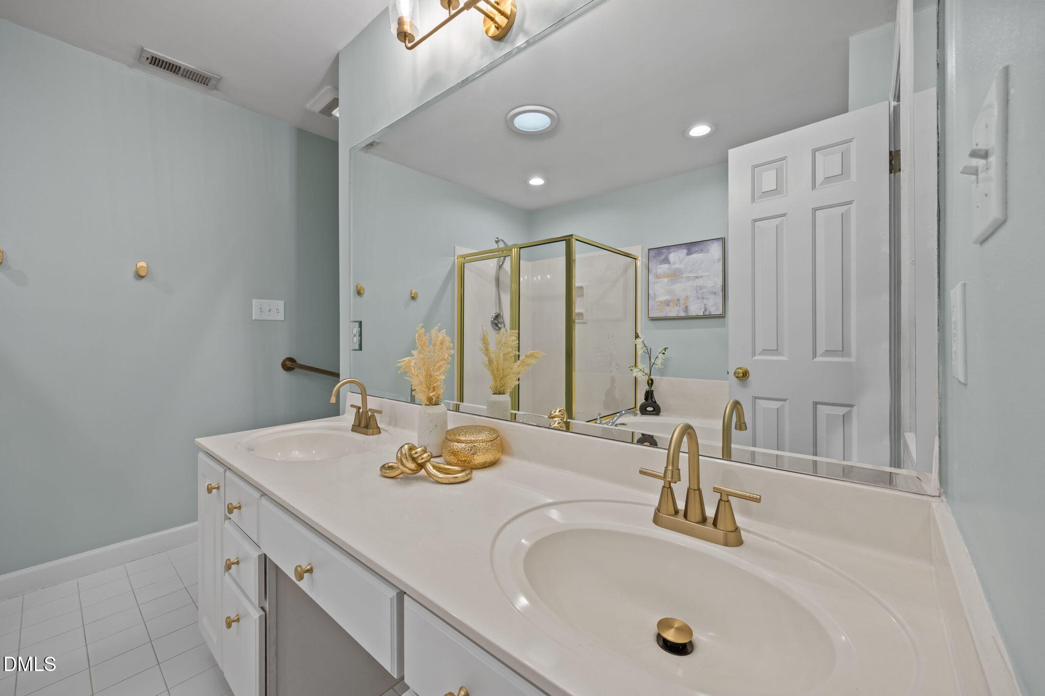 3409 Sir Colleton Court Raleigh, NC 27612 - Photo 15 of 25 a bathroom with a double vanity sink and a mirror