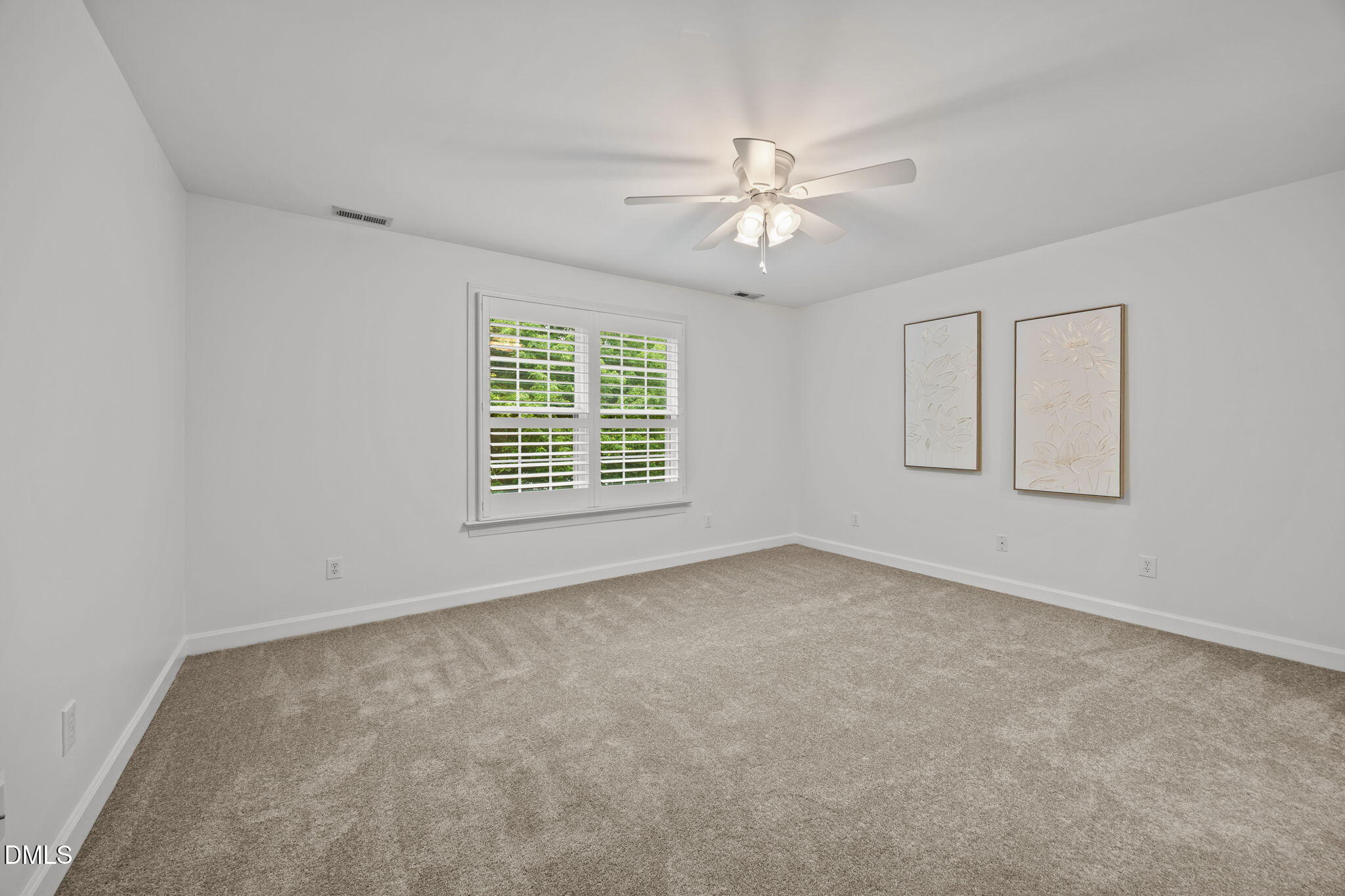 3409 Sir Colleton Court Raleigh, NC 27612 - Photo 18 of 25 an empty room with windows and fan