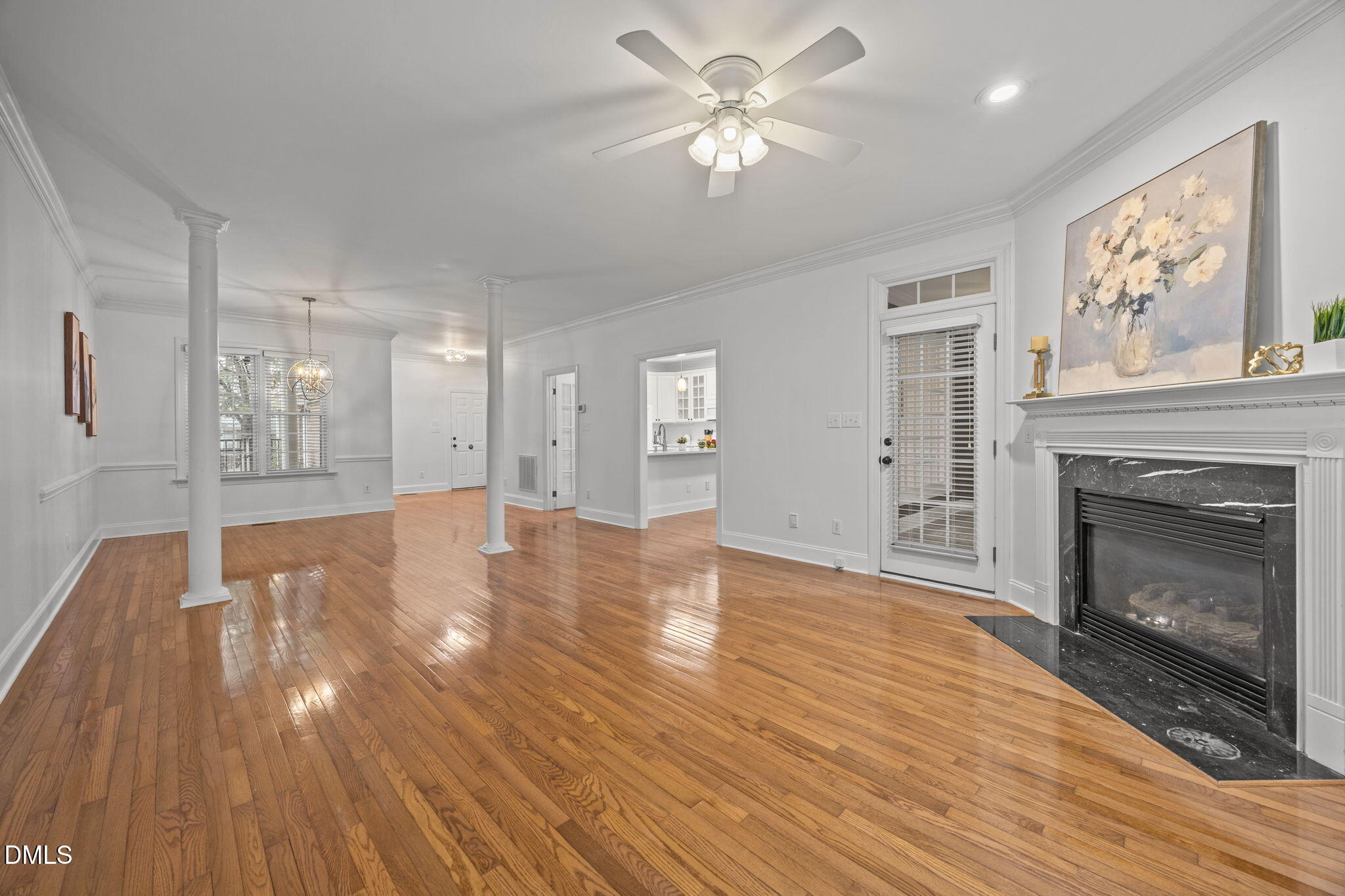3409 Sir Colleton Court Raleigh, NC 27612 - Photo 3 of 25 a view of an empty room with wooden floor and a fireplace