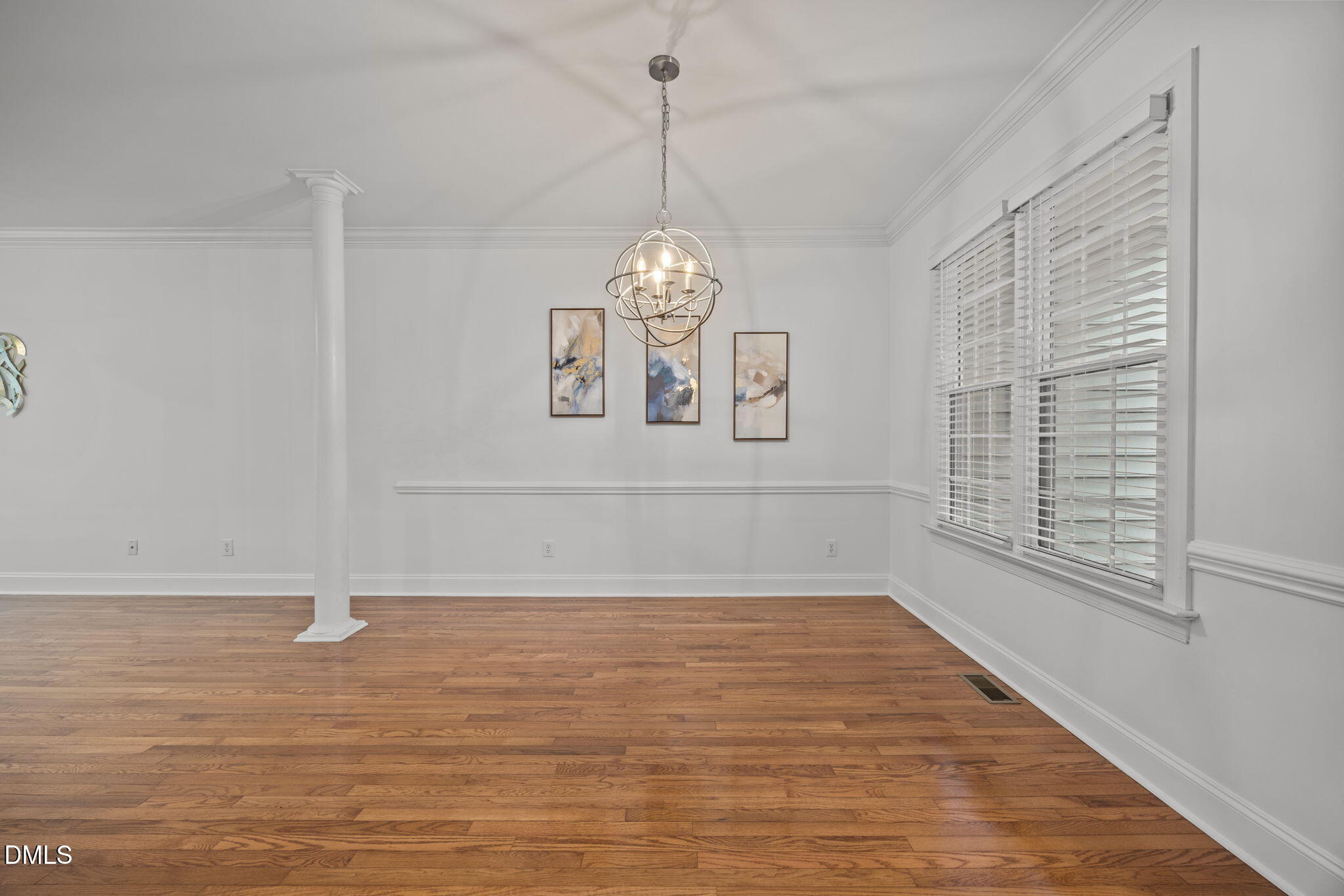 3409 Sir Colleton Court Raleigh, NC 27612 - Photo 4 of 25 a view of an empty room with window and wooden floor