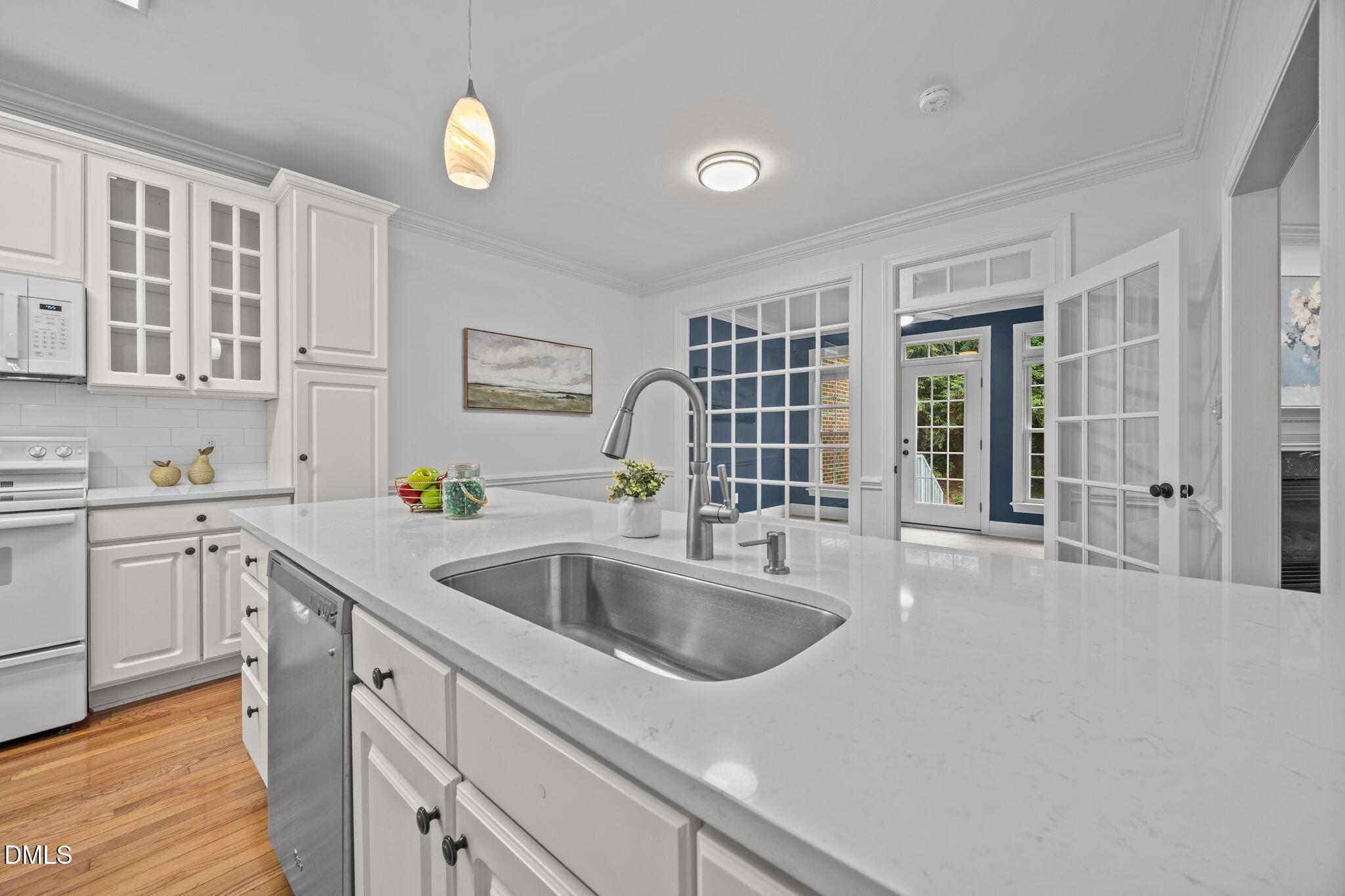 3409 Sir Colleton Court Raleigh, NC 27612 - Photo 10 of 25 a kitchen with a sink cabinets and wooden floor