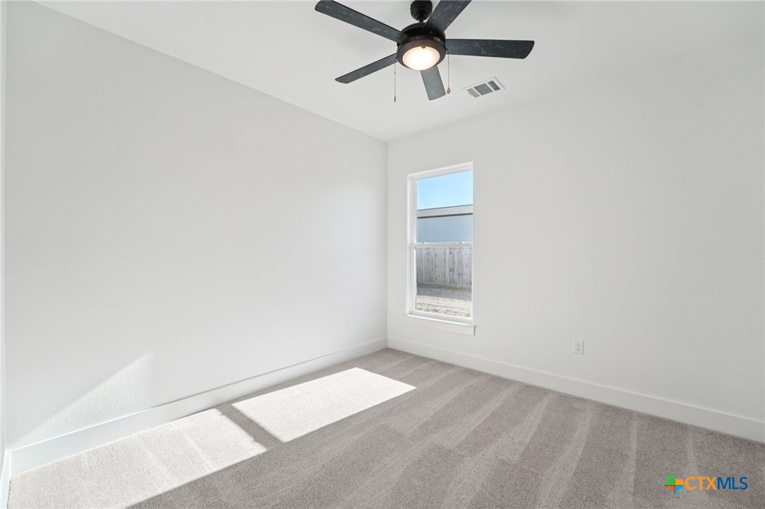 5207 Hollow Ranch Drive Salado, TX 76571 - Photo 27 of 37 an empty room with a window and a fan