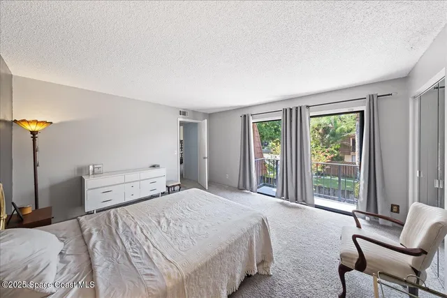 a bedroom with a bed and large window