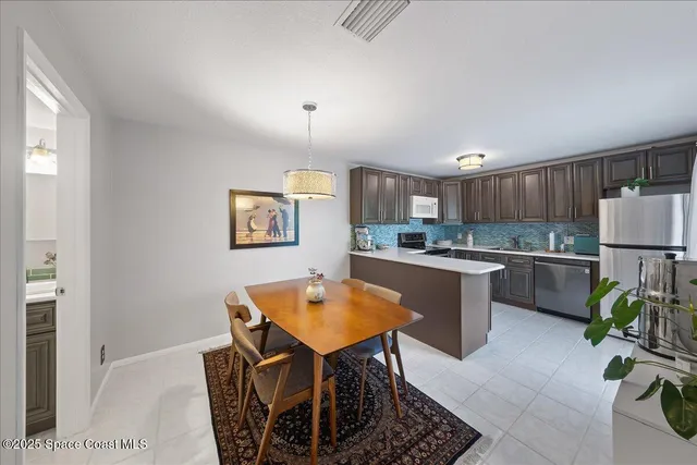 a kitchen with a table and chairs in it