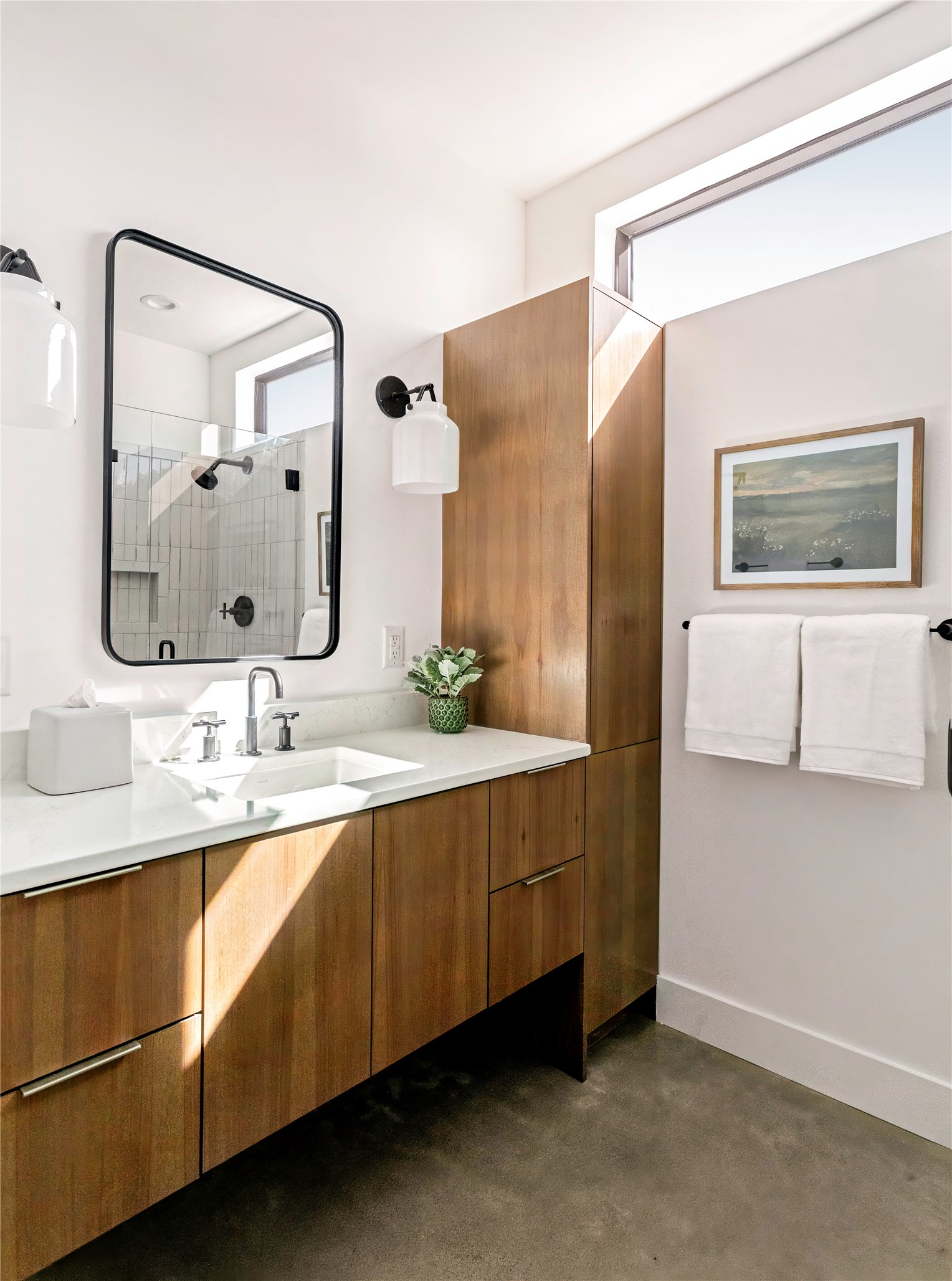 312 Hye Springs Road, Unit 106 Hye, TX 78635 - Photo 5 of 17 Contemporary bathroom featuring floating-style cabinetry, modern fixtures, and abundant natural light throughout the space. Walk-in glass shower in the mirror.