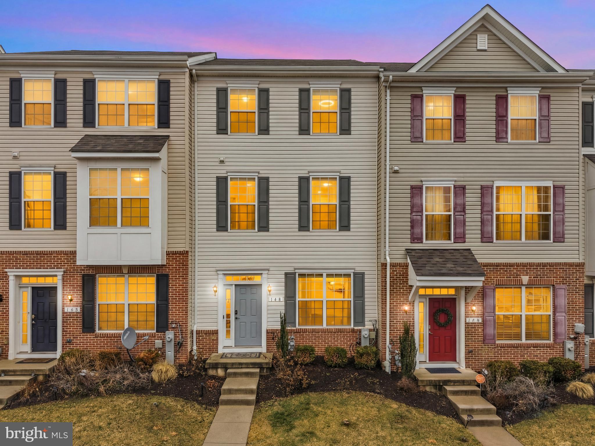 a front view of a residential apartment building with a yard