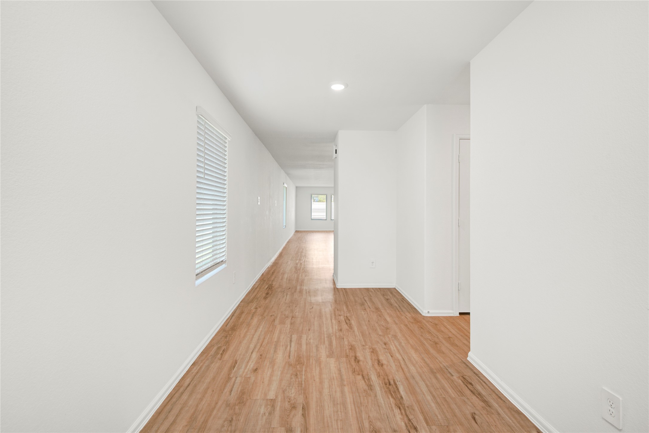 24126 Maple Turn Lane Hockley, TX 77447 - Photo 2 of 25 a view of a hallway with wooden floor