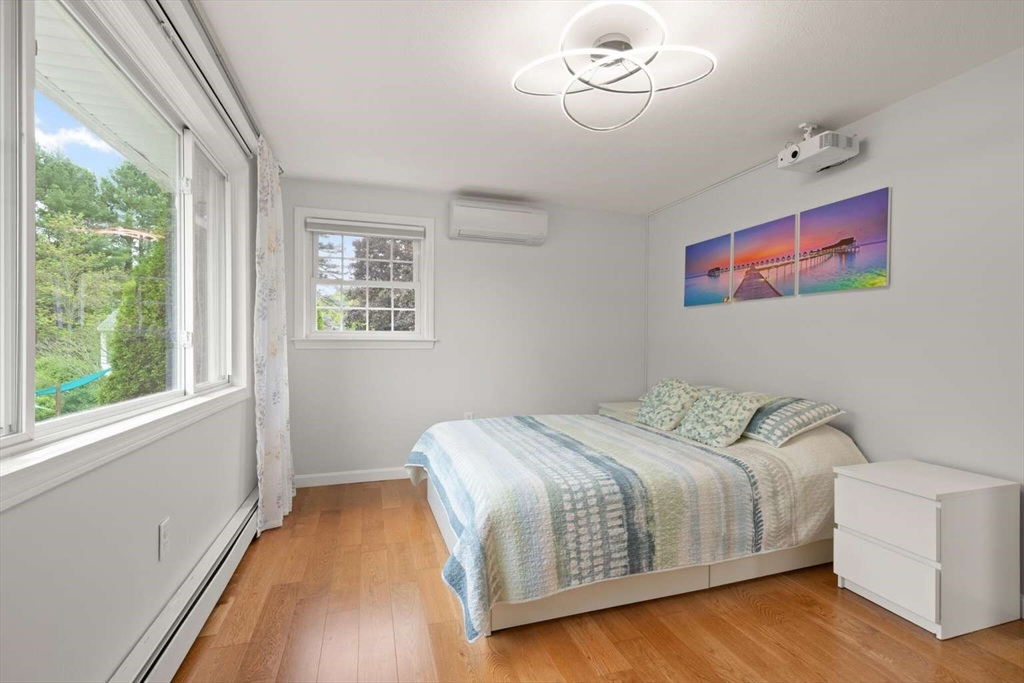 18 Winsor Road Billerica, MA 01821 - Photo 15 of 28 a bedroom with a bed and wooden floor