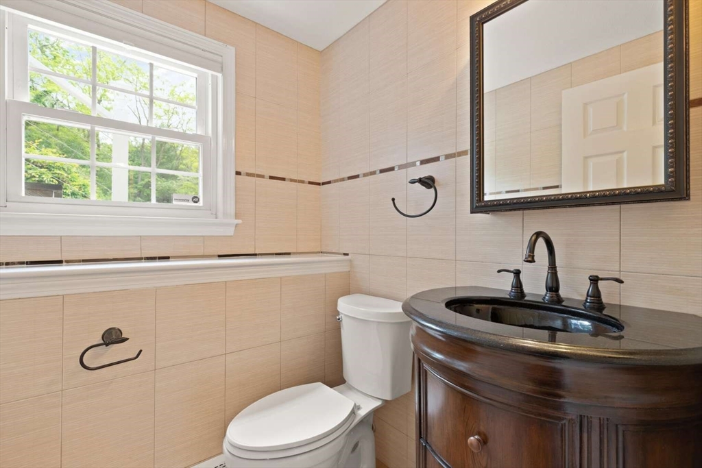 18 Winsor Road Billerica, MA 01821 - Photo 22 of 28 a bathroom with a sink a toilet and a mirror
