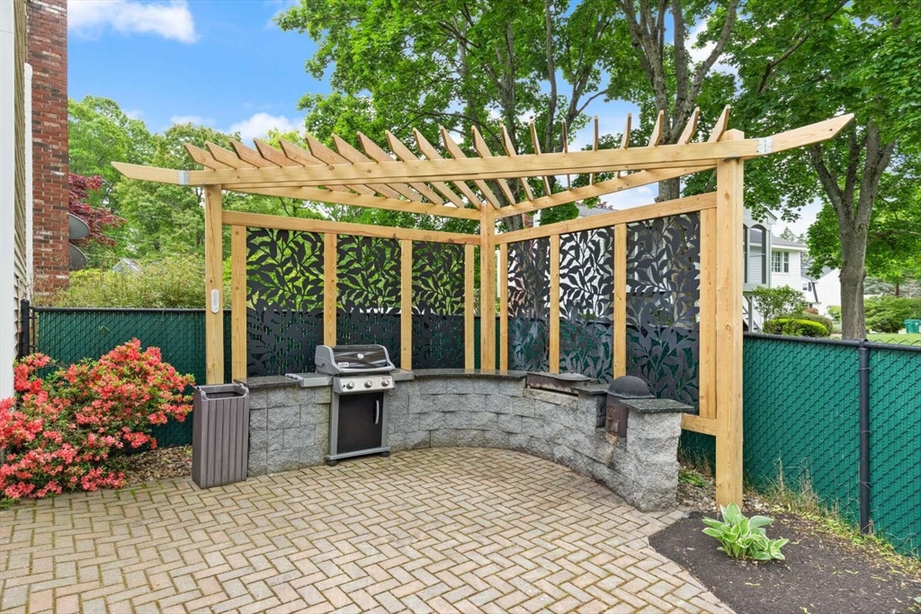 18 Winsor Road Billerica, MA 01821 - Photo 24 of 28 a view of a patio with a table and chairs and potted plants