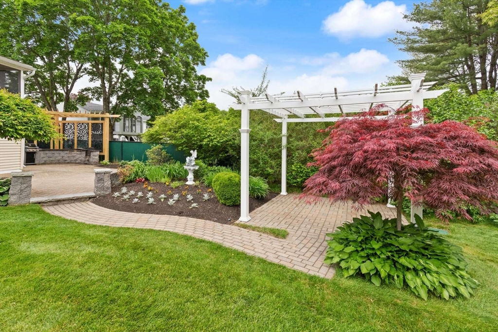 18 Winsor Road Billerica, MA 01821 - Photo 25 of 28 a view of a garden with a tree in front of the house