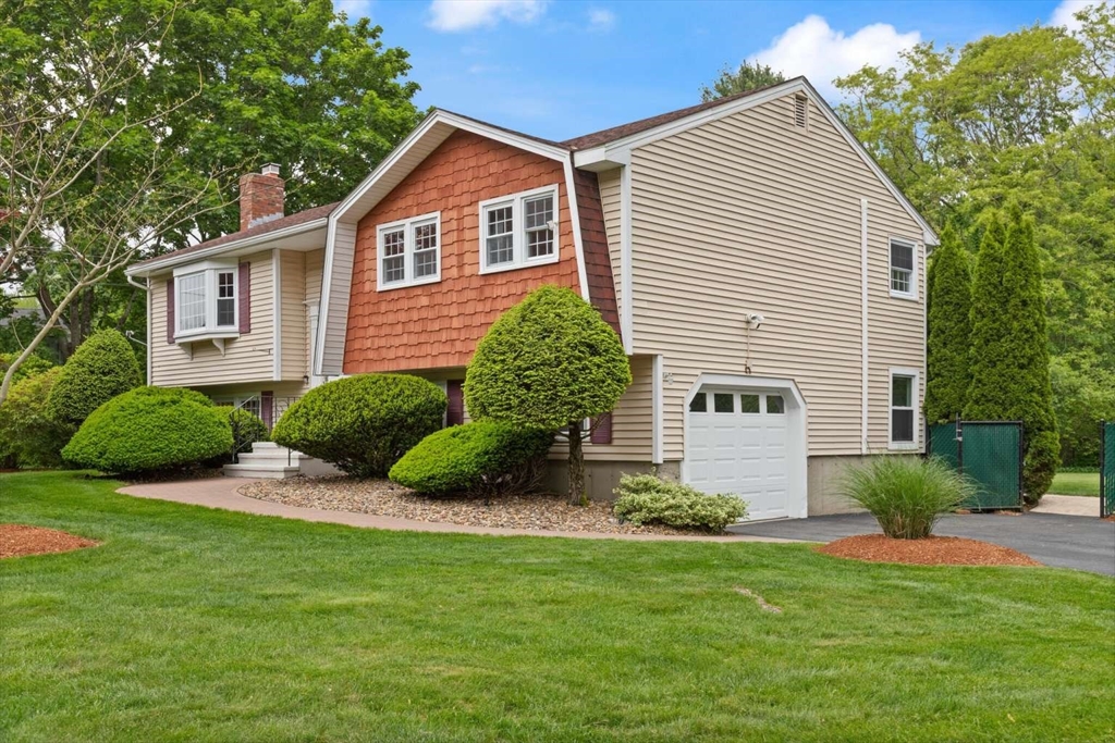 18 Winsor Road Billerica, MA 01821 - Photo 3 of 28 a view of a house with a yard and plants