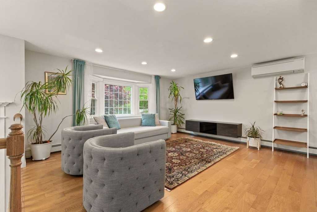 18 Winsor Road Billerica, MA 01821 - Photo 7 of 28 a living room with fireplace furniture and a flat screen tv