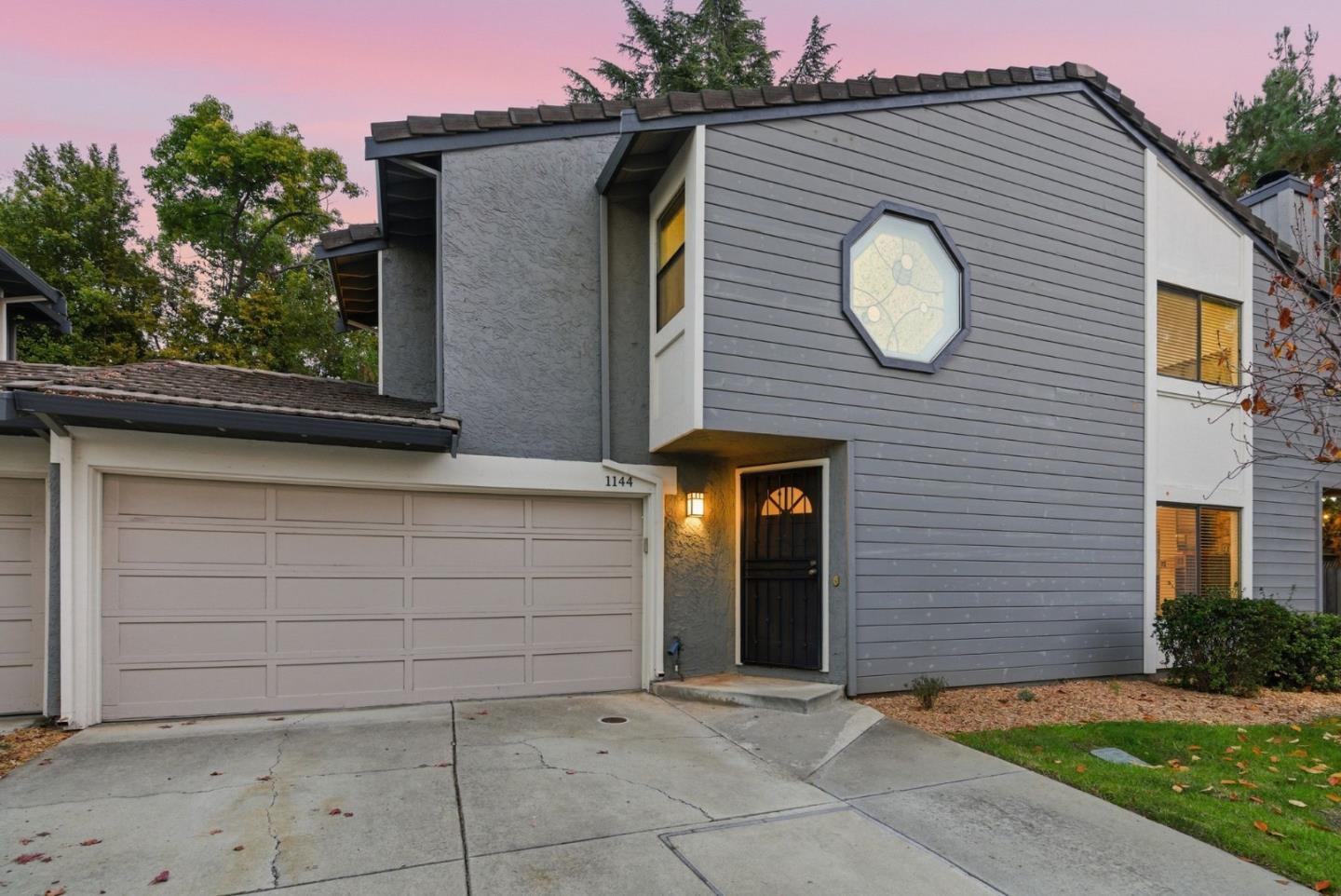 a front view of a house with a garden