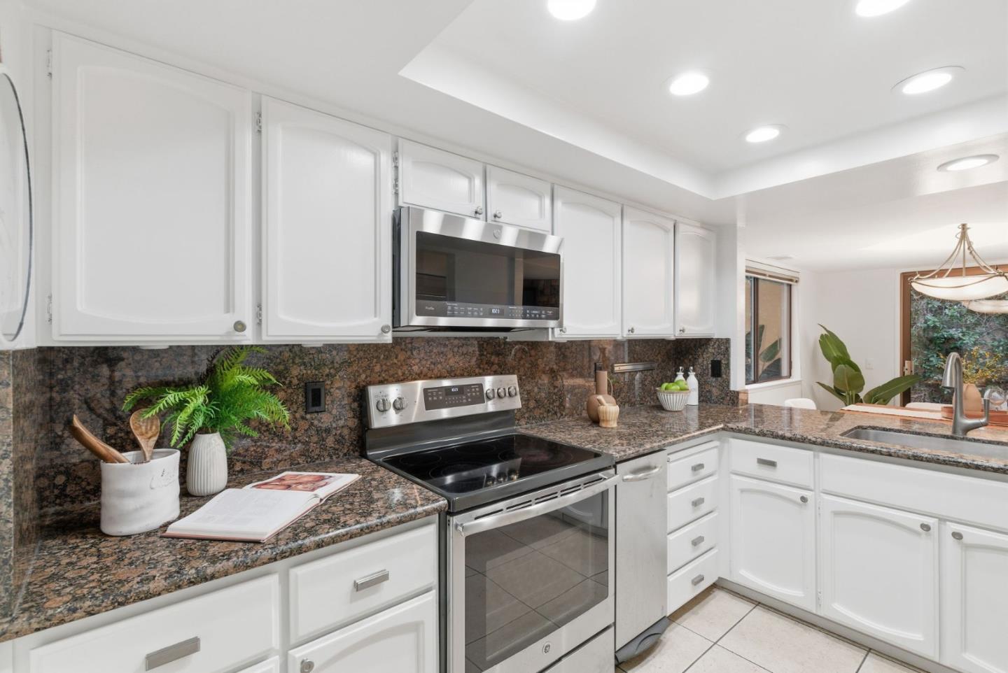 1144 Cherryview Lane San Jose, CA 95118 - Photo 12 of 77 a kitchen with granite countertop white cabinets and a stove