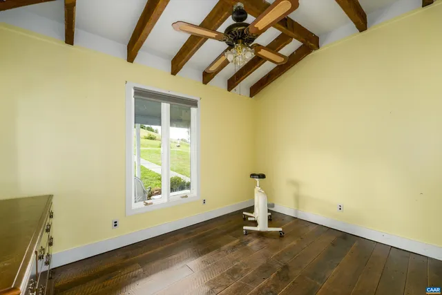 a view of a room with wooden floor and windows