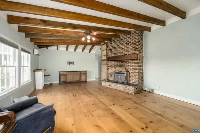 a view of a livingroom with furniture and a fireplace