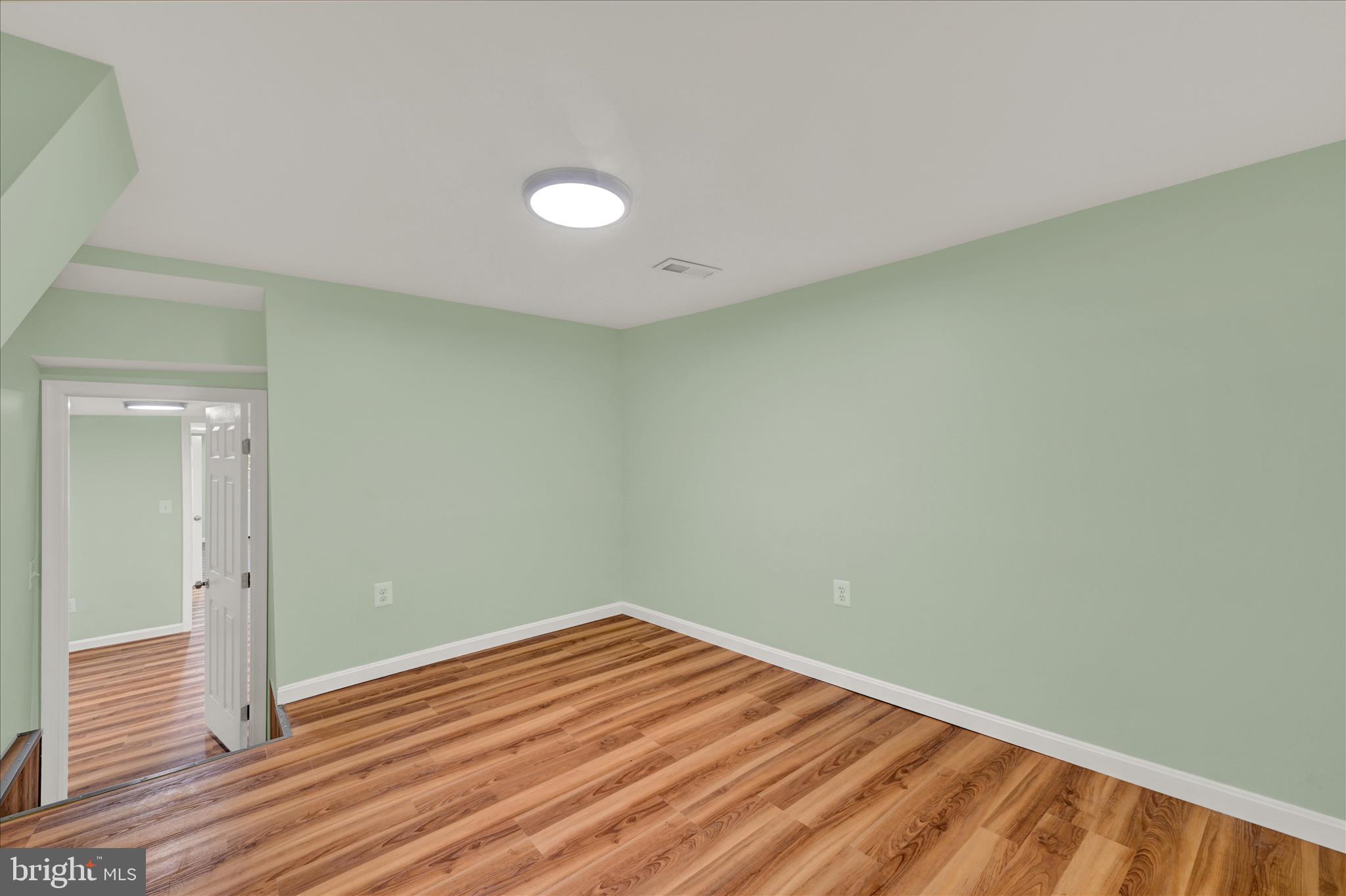 8511 Frederick Road Ellicott City, MD 21043 - Photo 15 of 36 a view of empty room with wooden floor