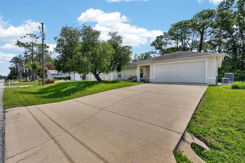 80 Roxboro Drive Palm Coast, FL 32164 - Photo 32 of 39 a front view of a house with a yard and garage