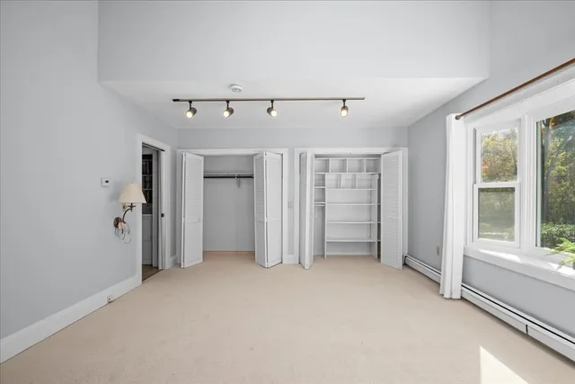 a bathroom with a granite countertop toilet sink and mirror