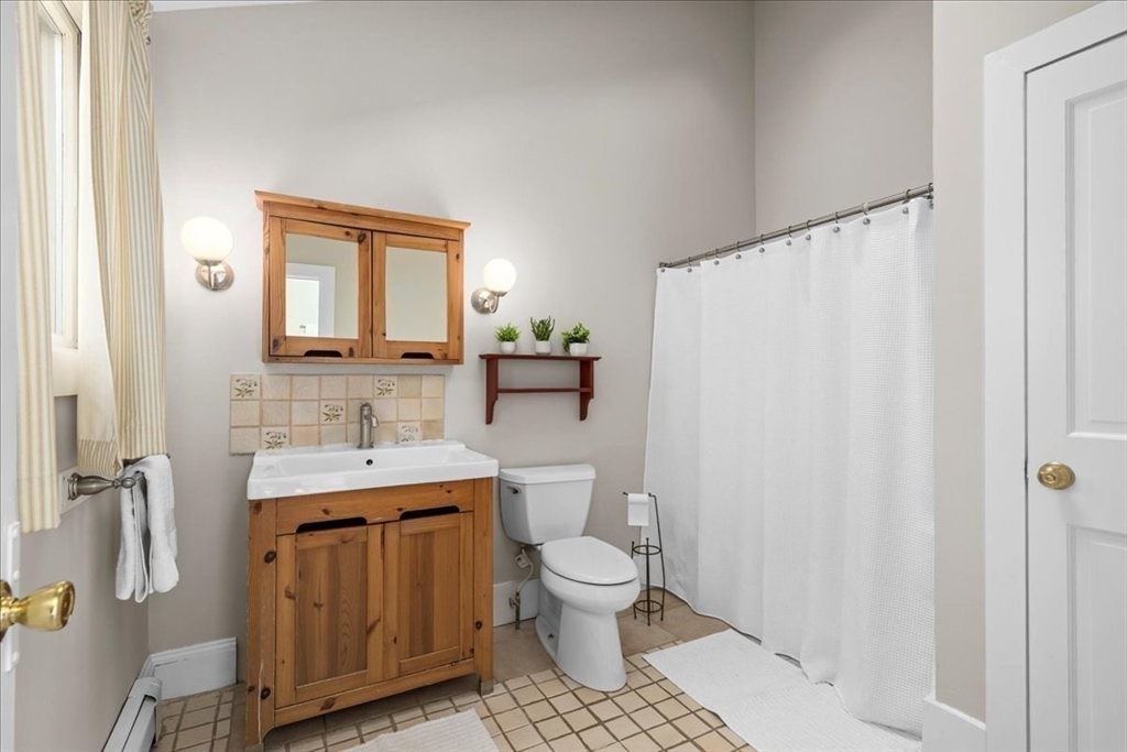 19 Gilmore Road Southborough, MA 01772 - Photo 19 of 42 a bathroom with a granite countertop toilet sink and mirror