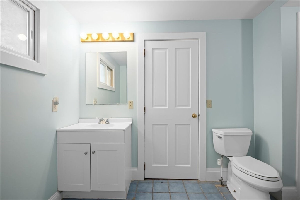 19 Gilmore Road Southborough, MA 01772 - Photo 26 of 42 a bathroom with a toilet sink vanity and mirror