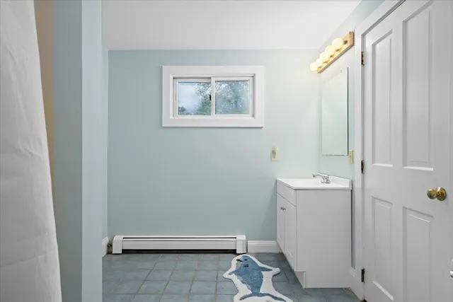 a view of a dining room with furniture large windows and wooden floor
