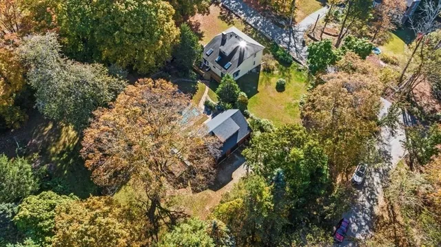 front view of a house with a yard and garden
