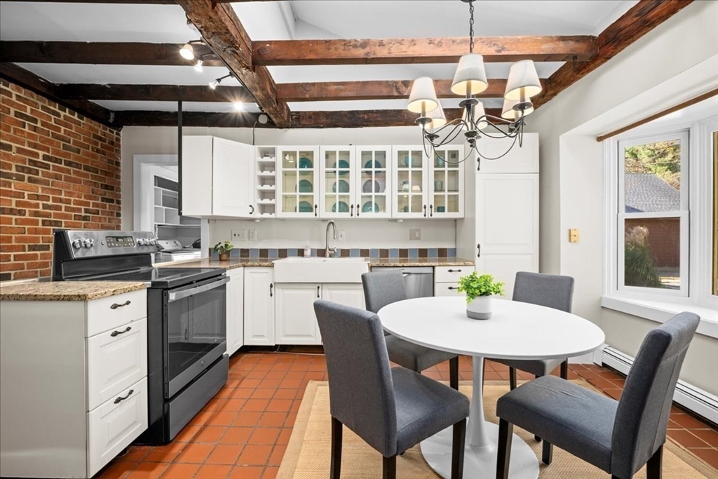 19 Gilmore Road Southborough, MA 01772 - Photo 6 of 42 a kitchen with a dining table chairs stainless steel appliances and cabinets