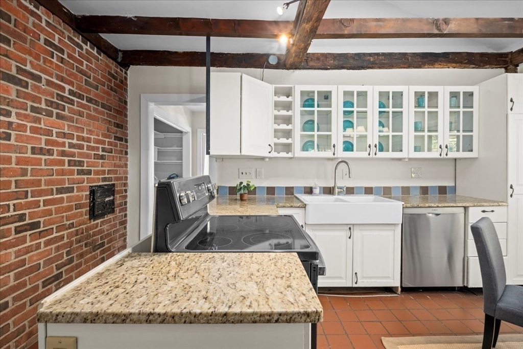 19 Gilmore Road Southborough, MA 01772 - Photo 10 of 42 a kitchen with a stove a sink and a refrigerator