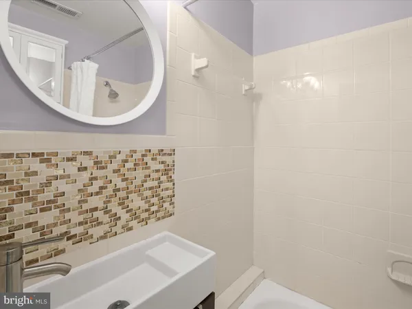 a bathroom with a sink a mirror and shower