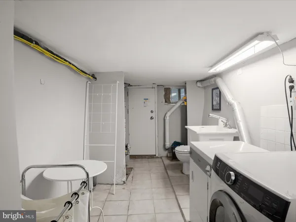a spacious bathroom with a sink a toilet and a mirror