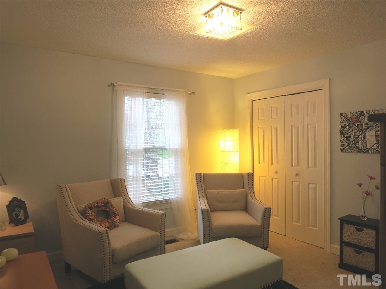 6408 Wynbrook Way Raleigh, NC 27612 - Photo 18 of 25 a living room with furniture and a window