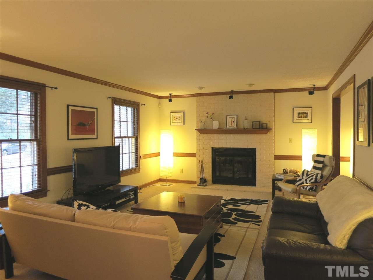 6408 Wynbrook Way Raleigh, NC 27612 - Photo 4 of 25 a living room with furniture and a fireplace
